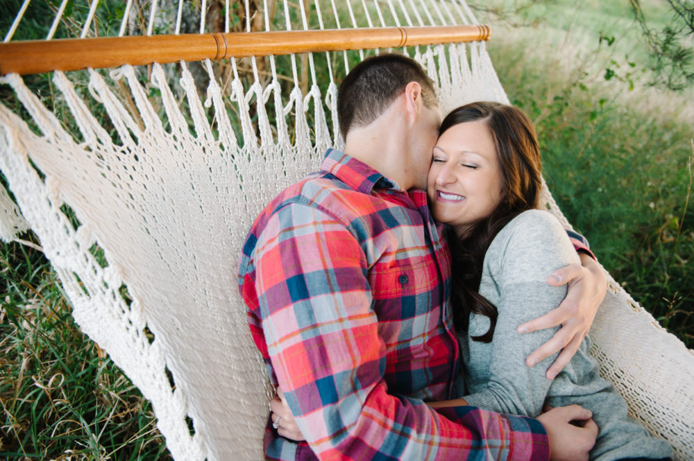 Snuggling in a hammock during engagement session in Omaha, Nebraska.